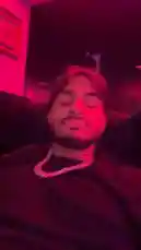 A man, identified as Justin Marc, relaxes on a couch with a friend in a room illuminated by vibrant pink lighting. They appear to be having a casual night out together, enjoying drinks and each other's company. by @sexxyjustin with Original Sound by sexxyjustin