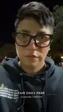 tufavlatiino 님이 만든 Original Sound 포함 @tufavlatiino 님이 만든 A person wearing glasses and a hoodie takes a selfie before showing a wide view of a nighttime soccer game in progress on a well-lit artificial turf field. Players in various colored jerseys are actively playing under bright stadium lights.