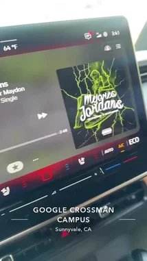 tufavlatiino 님이 만든 Original Sound 포함 @tufavlatiino 님이 만든 This video offers a brief glimpse inside the Google Crossman Campus in Sunnyvale, California. It begins with a close-up of a car's infotainment screen playing the song 'Mejores Jordans' by Mendo & Oscar Maydon, before panning out to reveal the modern glass exterior of the Google building. The scene captures the essence of the tech hub environment.