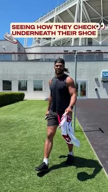 This short video shows several San Francisco 49ers players walking on a grassy field near their stadium. They all bend down to check under the soles of their shoes, seemingly searching for something hidden beneath them. The action is presented in a humorous and lighthearted manner, suggesting a team prank or a playful challenge among the players. by @sf49ers with Original Sound by Contains: hotel room - Xoly & thuggpint