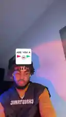 In this short, engaging clip, creator Christamic plays with a playful 'Are You A...' filter on his face. The filter presents a choice between a red flag and a green flag, which then animates onto his head to represent his selection. He reacts with animated expressions and gestures, creating a fun and interactive social media moment. by @christamic3 with Original Sound by christamic3