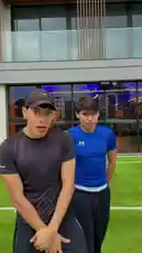 In this energetic clip, S E B A S 🧸 performs a series of cool dance moves and hand gestures on a green artificial turf field. He is joined by a friend, and they interact playfully, showcasing their coordination and fun personalities against the backdrop of a modern building. by @twinksebass with Original Sound by Contains: Me Estas Tentando - Wisin & Yandel