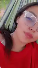 This short clip captures Mia enjoying a peaceful moment outdoors. She is lounging comfortably in a green and blue striped hammock, wearing a vibrant red top and stylish clear-framed glasses. The serene setting and her relaxed demeanor create a tranquil atmosphere perfect for a quick escape. by @alonamia22 with Original Sound by alonamia22