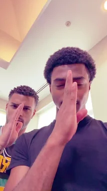In this short clip, Jeremiah Brown and a friend are seen posing for the camera inside a bright room. Both men make peace signs with their fingers while looking directly at the lens. The moment captures a candid, friendly interaction, highlighted by upbeat music playing in the background. by @findjeremiah with Original Sound by findjeremiah
