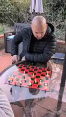 Two players are locked in an intense chess game outdoors. One player makes a move, but his opponent seems to be contemplating a different strategy. Suddenly, the board is knocked over, sending pieces flying. What caused the dramatic end to their match? by @chesscom with Original Sound by chesscom
