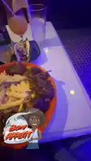 This clip offers a close-up view of a delicious meal served at a restaurant. The scene features a vibrant red plate filled with what appears to be steak and fries, accompanied by a refreshing cocktail garnished with a lemon slice. In the background, other dishes and a menu card are visible, suggesting a casual dining atmosphere. The overall ambiance is enhanced by soft, ambient lighting, creating a cozy and inviting mood. by @dimpled.diva02 with Original Sound by dimpled.diva02