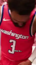 A player from the Washington Wizards team poses for a professional photoshoot in his red jersey. The session features dynamic shots against a vibrant pink backdrop with cherry blossoms, as well as more casual moments on a blue screen. He is seen holding a basketball, adjusting his jersey, and wearing a prominent chain necklace. by @washwizards with original sound