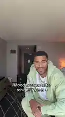 In a hotel room setting, Jeremiah Brown reacts to a sports game ending in a 2-2 draw. He is seen sitting, then standing and dancing energetically while text on screen reads 'Mood because after tonight it's 2-2' accompanied by an alien emoji. The audio features upbeat music and cheering, capturing his celebratory mood. by @findjeremiah with Original Sound by findjeremiah