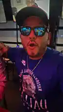 In a lively sports bar, Tomas Guerrero, wearing a Dallas Cowboys t-shirt and cap, addresses the camera directly. He points towards his companion, another man in a pink shirt, before turning back to speak enthusiastically. The background shows other patrons and TVs, creating the atmosphere of a fan gathering during a game. by @tomasg3901 with Original Sound by tomasg3901