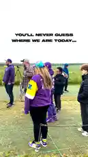 A group of people, including fans of the Minnesota Vikings, gather on a grassy field before revealing their surprising location: the ancient monument of Stonehenge. The video uses text overlays like 'YOU'LL NEVER GUESS WHERE WE ARE TODAY...' and 'STAY TUNED FOR THE PICK!' to build suspense and hint at a sports-related reveal. by @vikings with Original Sound by vikings