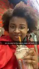 A young woman named Liah shares a candid moment before heading to the casino. She holds a Dunkin' drink, smiles at the camera, and text on screen reads 'on my way to the casino, wish me luck.' The scene captures a slice-of-life moment with a personal touch. by @dimpled.diva02 with original sound