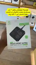 A hand holds up the retail box for the QUFEX Multi-Port Ultra High-Speed Socket. The packaging highlights key features like '40W/PD20W' power delivery and a '3M' cable length. Arabic text overlays on the screen mention '3-meter cable' and 'charging speed'. The background shows a store shelf with other electronics, suggesting a product demonstration or unboxing. by @power.ch01 with original sound