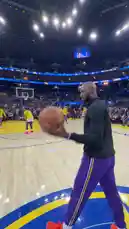 In a heartfelt tribute, a legendary figure from the Los Angeles Lakers stands on the court, observing his former team during a practice session. Dressed in purple and gold, he embodies the team's enduring spirit. This moment captures the essence of mentorship and the timeless connection between a great player and the franchise he helped build. by @lakerssnaps with original sound