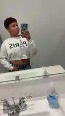 In a quick, stylish bathroom selfie, Charisma 😈 shows off her white 'PARIS' crop top paired with distressed denim shorts. She strikes a pose in front of a mirror, highlighting her outfit and confident look. This relatable moment captures a simple yet effective way to document daily style. by @chacha_22 with Original Sound by chacha_22