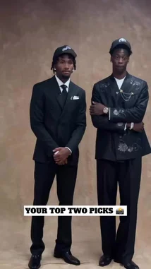 In a behind-the-scenes moment, two tall athletes, dressed in sharp black suits and caps, stand side-by-side against a neutral backdrop. They make coordinated hand gestures, smiling for the camera in what appears to be a photoshoot or promotional event. by @nba with Original Sound by nba