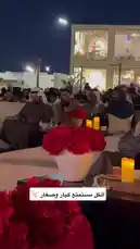 Experience the elegance of a private nighttime jalsah gathering hosted by إيفنت جَلسة | Jalsah event. This exclusive social event features guests dressed in traditional attire, seated comfortably on plush white couches under ambient lighting. The atmosphere is enhanced by vibrant red floral centerpieces, flickering candles, and a modern two-story building in the background, creating a sophisticated and intimate setting perfect for networking and relaxation. by @jalsahevent with jalsahevent by Original Sound