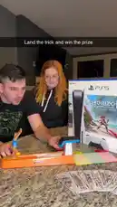 In this lively scene, Emiliano and a friend gather around a kitchen island to unbox a new PlayStation 5 console. They then shift their focus to a colorful Hot Wheels track set, where they playfully launch toy cars. The atmosphere is casual and fun, capturing a moment of shared entertainment. by @amiliflips with Tetris by Doctor P