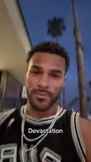 In this poignant clip, Jeremiah Brown shares a personal moment of emotional vulnerability outdoors at dusk. Wearing a San Antonio Spurs jersey and prominent diamond chains, he covers his face with his hand while the word 'Devastation' is displayed on screen. The somber piano music underscores the gravity of the situation, capturing a raw reaction to a significant event. by @findjeremiah with Original Sound by findjeremiah