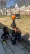 Two young children enjoy playing with a basketball launcher in their sunny backyard. One child operates the machine while the other watches intently as a ball is launched into the air. by @marcus.randall with Original Sound by marcus.randall