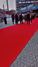 This video captures a vibrant red carpet event outside a modern IMAX theater. Attendees in stylish attire walk the carpet under dramatic evening lighting, with a large building and tree-lined sidewalk forming the backdrop. The atmosphere suggests a premiere or special screening, offering a glimpse into a glamorous entertainment gathering. by @junaidkhan with Original Sound by junaidkhan
