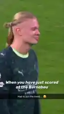 This video captures Erling Haaland celebrating a goal scored at the Santiago Bernabeu stadium. The scene transitions to a man in a dark, blue-lit environment, creating a contrast between the high-energy sporting event and a more introspective mood. by @erling.haaland with Original Sound by erling.haaland