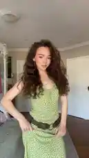 Ruby Jay dances energetically in a stylish green polka dot dress, showcasing her playful personality and dance moves in a cozy bedroom setting. by @iamrubyjay with Original Sound by iamrubyjay