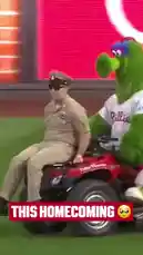 A heartwarming moment unfolds at a Philadelphia Phillies game where a veteran, returning home after deployment, is joyfully reunited with his family on the field. He shares a special ride on a red utility vehicle with the team's beloved mascot, the Phillie Phanatic, before being embraced by his children and wife. This touching tribute captures the essence of a true 'homecoming'. by @mlb with Original Sound by mlb