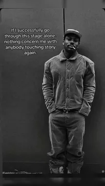 This black-and-white video features HeIsZion standing against a plain wall. Text on screen reads, 'If I successfully go through this stage alone. nothing concern me with anybody touching story again.' He is wearing a cap, jacket, and pants, with his hands in his pockets. The static shot and introspective message suggest a moment of self-reflection and resilience. by @eliza_webb25 with Obito♾️ by Dee🐐