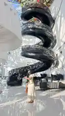 Experience a breathtaking tour of a modern architectural marvel featuring a dramatic black spiral staircase with intricate metalwork, set within a sunlit atrium. Watch as a stylish woman explores the space, highlighting the elegance and design of contemporary interiors. This stunning visual journey captures the intersection of art, structure, and lifestyle—perfect for design lovers and architecture enthusiasts. by @everythingnaddy with original sound