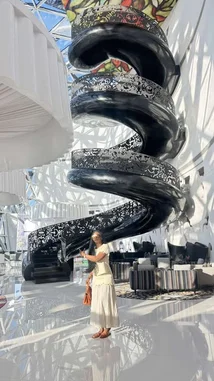 Experience a breathtaking tour of a modern architectural marvel featuring a dramatic black spiral staircase with intricate metalwork, set within a sunlit atrium. Watch as a stylish woman explores the space, highlighting the elegance and design of contemporary interiors. This stunning visual journey captures the intersection of art, structure, and lifestyle—perfect for design lovers and architecture enthusiasts. by @everythingnaddy with original sound