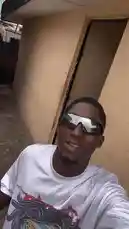 In this candid street-style moment, Ħølÿ MolŁŶ showcases his bold fashion sense with reflective sunglasses and a graphic tee. The urban backdrop adds to the cool, confident vibe, capturing a slice of everyday style. by @big20247443 with Eti romipin abi😂😂 by Chicken 😂
