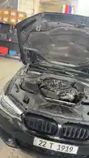 This short clip provides a close-up view of a black BMW's engine bay with the hood open. The camera focuses on the intricate details of the engine components, showcasing the car's mechanical heart. In the background, a workshop environment is visible, suggesting a setting for maintenance or repair. by @hawkar_service with Original Sound by hawkar_service