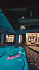 Experience a serene night view of a contemporary villa's illuminated pool. The modern architecture features expansive glass windows and stylish overhangs, creating a tranquil mood. This scene captures the essence of luxury living and design aesthetics. by @ghazi_855 with 🐐✨🪬🦋 by 🤎🤎🤎🤎