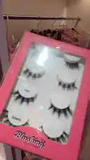 A close-up showcase of Blushing Boutique's 'Soft lashes, strong game, Pure luxury' false eyelash collection. The pink packaging elegantly displays four distinct styles: Bratz, Barbie, Flick, and Sultana. This beauty product highlight is perfect for anyone seeking to enhance their look with a touch of glamour. by @bx301a with 🍒🧚🏻🪸✨🫧 by Ley