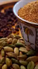 A close-up shot of aromatic spices, including whole cardamom pods and ground spice mix, arranged beautifully in a decorative cup. This visual is paired with a heartfelt Arabic song about faith, family, and tradition, creating a sensory-rich experience that celebrates culture, hospitality, and the art of gathering. by @soldere.ledyafa with Original Sound by soldere.ledyafa