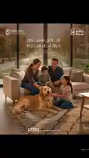 A family enjoys a warm moment together on their living room sofa, with their golden retriever, inside a modern apartment. The scene promotes 'Bravo' by Ouda Developments, highlighting a comfortable and welcoming lifestyle. Contact details and the website are displayed. by @ouda_dev with A Day in My Life by Soft Boy