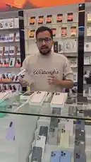 A salesperson at 'Wistwick's' electronics store in Abu Dhabi presents a range of used and refurbished smartphones. He showcases iPhone 16 Pro models with details on battery percentage, warranty status, and pricing. The presentation includes trade-in offers, such as upgrading from an iPhone 16 Pro Max to a newer model, and highlights other available devices like the Samsung S25 Ultra. The store features various accessories and multiple units of different colors on display. by @super_golden7 with Original Sound by super_golden7