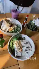 Watch as the table comes alive with fresh burritos, vibrant salads, and a purple smoothie at Melon's. This cozy dining moment captures the essence of a satisfying meal, perfect for food lovers and lifestyle enthusiasts. by @dsunmusic with original sound