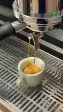 Experience the craft of Sequence Coffee with a close-up of rich espresso being pulled into a cup, followed by a server presenting it alongside a decadent chocolate-drizzled cheesecake. This elegant pairing highlights the quality of coffee shop treats. by @sequence-coffee with Original Sound by sequence-coffee