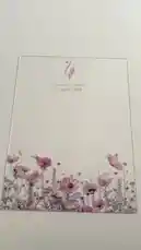 A close-up view of a beautifully designed invitation card for Sabrina Sadiq's event on April 17, 2026. The card features delicate pink and white flowers with butterflies at the bottom, set against a clean, elegant background. This visually appealing announcement is presented by متجر ريزن تبوك, highlighting a sophisticated and artistic approach to event invitations. by @r200an with original sound
