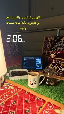A serene morning scene from Merchat Noor's personal space, showcasing a cozy study setup with a laptop, coffee, and tea. The Arabic text overlay reads 'The morning is for the dawn, and the night is for sleep,' setting a peaceful tone. This tranquil environment highlights a balanced lifestyle focused on productivity and self-care. by @ghs-rhf with original sound