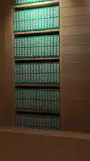 This video provides a close-up, static view of numerous green pizza boxes neatly stacked in rows against a wooden wall. The consistent branding and orderly arrangement create a visually striking pattern, ideal for discussions on design, packaging, and visual marketing. by @i_vcil with original sound
