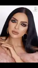 This video features makeup artist Aljawharah Artist 💄 showcasing her stunning signature glamour look. The scene opens with a close-up of her flawless face, highlighting bold winged eyeliner, sculpted brows, and soft pink lips. She wears elegant gold hoop earrings and a plush pink fur top, creating a luxurious aesthetic. Her long, sleek black hair frames her face as she gently touches her neck, exuding confidence and artistry. The clean white background emphasizes the details of her makeup, making it ideal for aspiring artists seeking inspiration. This visually captivating tutorial is designed to engage viewers and encourage them to explore more of her work. by @aljawharah_art with original sound