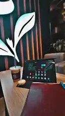 Watch as غازي الحميدي showcases his ideal workspace in a modern coffee shop. This scene captures a perfectly arranged table with a tablet, notebook, and iced coffee, all set against a stylish leaf-themed backdrop. It's a visual guide to creating a productive and inspiring environment. by @ghazi_855 with اشرب قهوتك☕️ by KK9L0