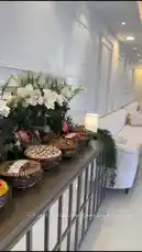 This stylish tour showcases a modern home's exterior and interior spaces. It begins with a view of a minimalist white archway and then moves inside to reveal a beautifully decorated living room with a long sofa, elegant floral arrangements, and a buffet table laden with appetizers. The overall aesthetic is clean, bright, and sophisticated. by @rii.38 with ♥️♥️♥️♥️♥️♥️♥️ by LOVELOVELOVELOVELOVELOVELOVELOVELOVELOVELOVELOVE