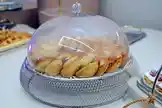 This close-up scene shows a beautifully arranged pastry display under a glass cloche, highlighting professional presentation techniques for desserts and snacks. The silver mesh base adds a touch of elegance, perfect for parties or cafes. by @blue11sweet with original sound