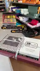 This video showcases an elegant chocolate gift box from Brown Chocolate, featuring a variety of gourmet chocolates and a beautifully designed presentation. Viewers see close-ups of the assorted chocolates inside, highlighting their rich colors and textures. The packaging includes Arabic text, suggesting a Middle Eastern market focus, and mentions '85% off,' indicating a promotional sale. The setting appears to be a well-lit retail store with shelves stocked with other premium products, emphasizing quality and exclusivity. by @ch11.30 with original sound