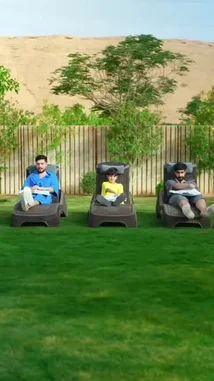 In a sunny backyard setting, three individuals are seen relaxing on lounge chairs, each holding a newspaper over their face. As they simultaneously lift the papers, the letters 'R', 'J', and 'R' are revealed, spelling out 'RJR'. This playful reveal suggests a personalized message or logo, possibly related to the creator named RJ. The scene transitions to a close-up of a circular logo featuring the stylized initials 'RJ', confirming the branding theme. by @rjrobes with Original Sound by rjrobes