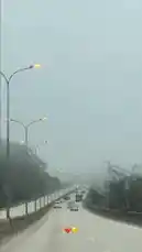 This cinematic clip captures a serene drive along a fog-covered highway during early morning hours. The road stretches into the distance, lined with evenly spaced streetlights glowing softly against the misty backdrop. Vehicles move steadily ahead, creating a tranquil yet dynamic atmosphere. A male voice speaks in Arabic, adding a narrative layer to the journey. This atmospheric scene evokes feelings of calm, introspection, and travel, perfect for vlogs, meditation, or ambient soundscapes. by @nowaira-11 with وداعت الله لندن 🇬🇧 by الخالدي