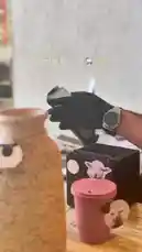 A close-up, step-by-step look at a barista using a smartphone to process a coffee order through a point-of-sale (POS) system. The screen shows a QR code being scanned, followed by a receipt being printed from a compact thermal printer. The final shot reveals the prepared pink cup next to a decorative vase, capturing the modern workflow of a busy café. by @fox_cofee with Original Sound by fox_cofee